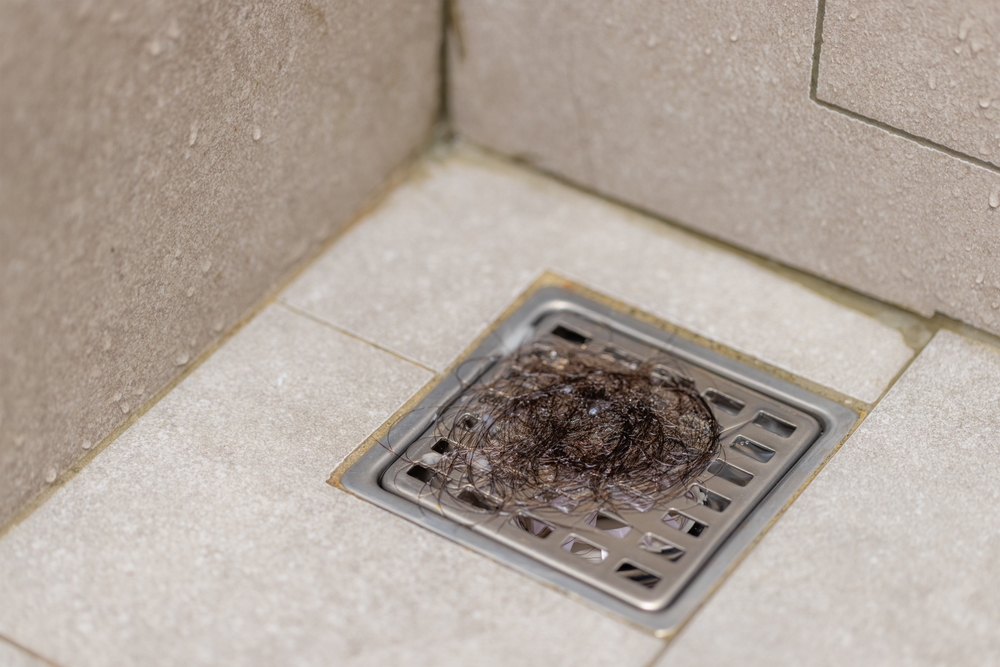 Professional plumber using hydro jetting for grease-clogged sewer lines to clear heavy buildup